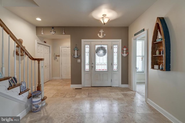 foyer entrance with recessed lighting, stairway, and baseboards