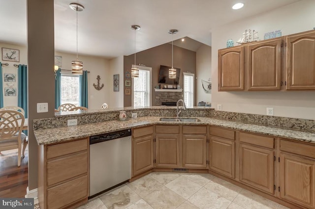 kitchen featuring a sink, light stone countertops, a peninsula, and stainless steel dishwasher