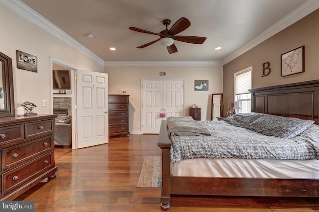 bedroom with recessed lighting, crown molding, baseboards, and wood finished floors