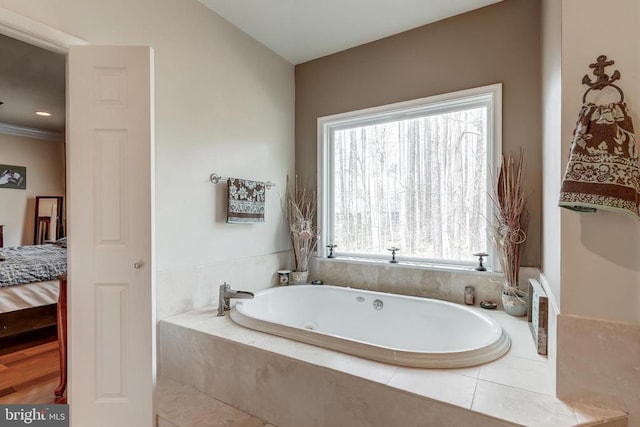 full bathroom featuring a garden tub and ensuite bathroom