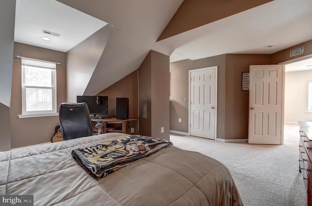 carpeted bedroom featuring visible vents, baseboards, and vaulted ceiling