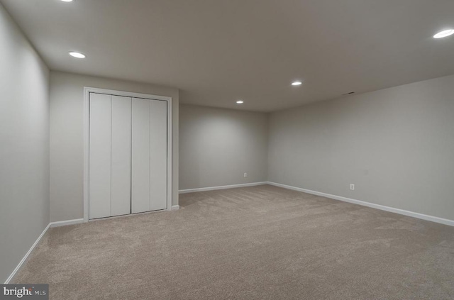 unfurnished bedroom featuring recessed lighting, a closet, baseboards, and carpet flooring