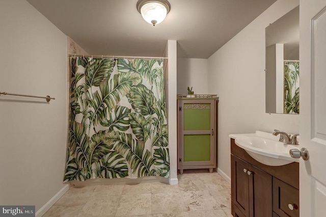 full bathroom with baseboards and vanity