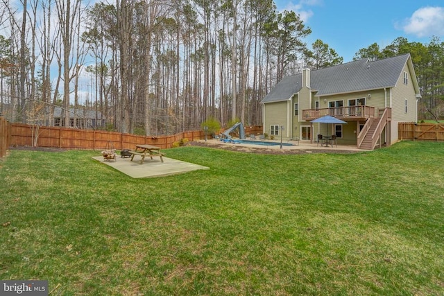 view of yard featuring stairway, a patio, a deck, and a fenced backyard