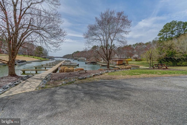 exterior space featuring a water view and a dock