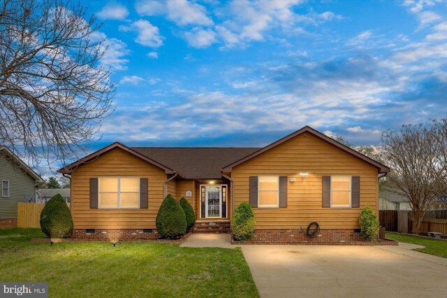 ranch-style home with fence, concrete driveway, crawl space, and a front yard