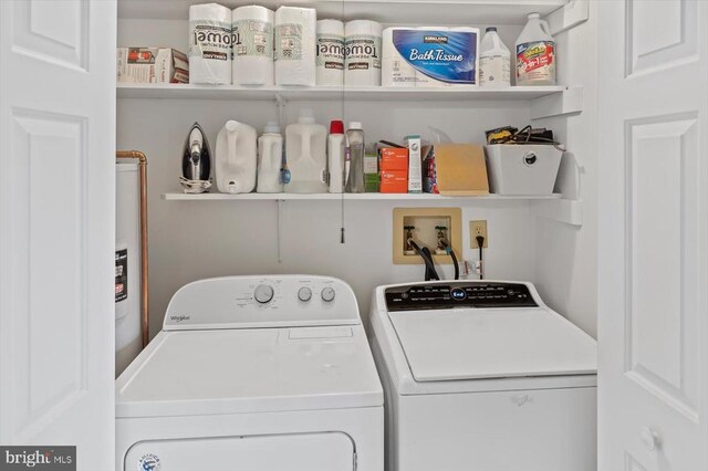 clothes washing area featuring independent washer and dryer and laundry area