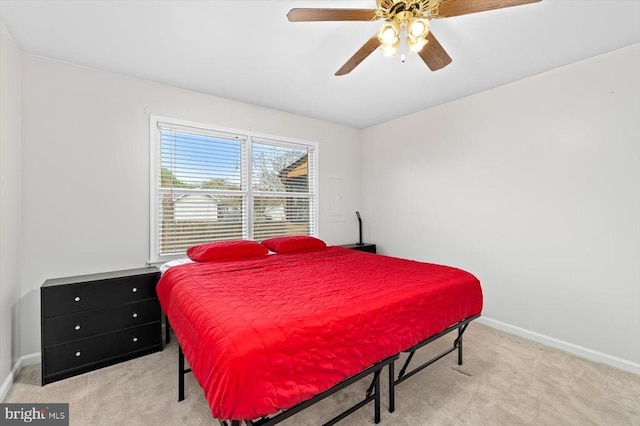 bedroom with baseboards, a ceiling fan, and light colored carpet