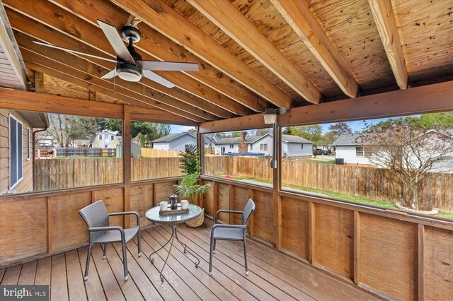 deck with fence, a ceiling fan, and a residential view