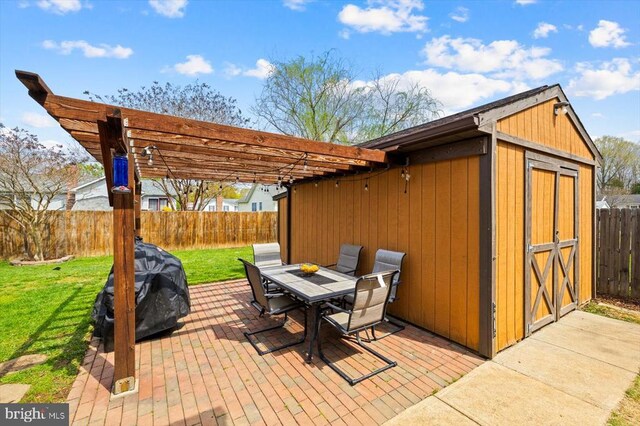 view of patio / terrace featuring an outbuilding, a shed, a fenced backyard, outdoor dining area, and a pergola