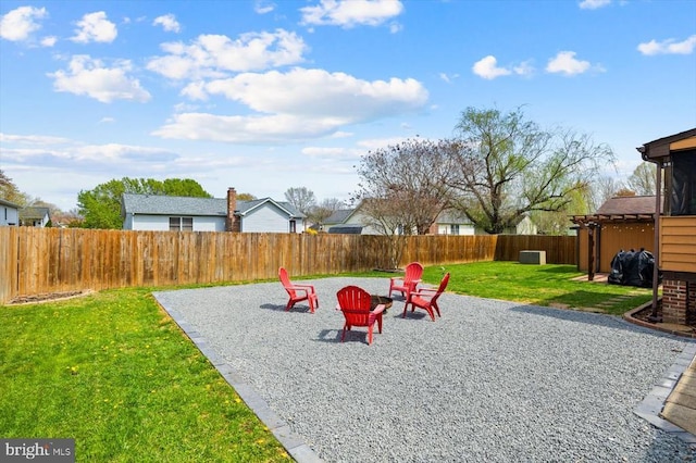 view of yard featuring a patio, an outdoor fire pit, and a fenced backyard