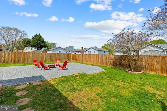view of yard with an outdoor fire pit, a fenced backyard, and a patio area