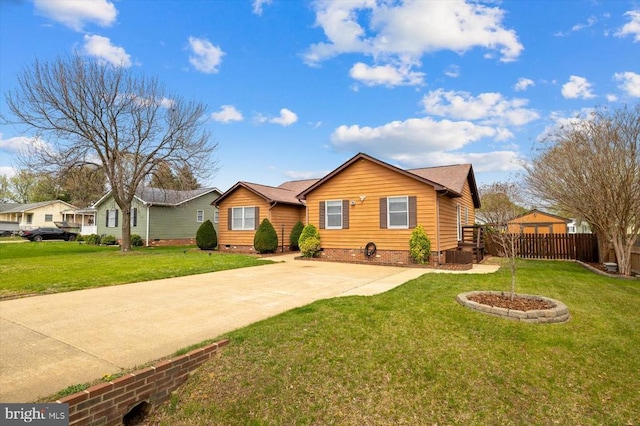 ranch-style home with a front lawn, crawl space, fence, and concrete driveway