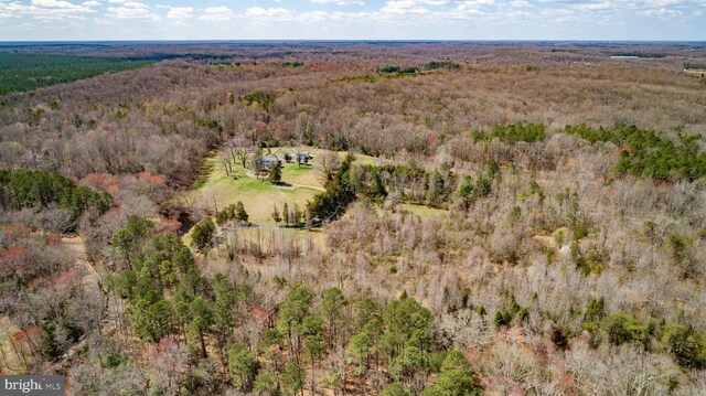 drone / aerial view featuring a forest view