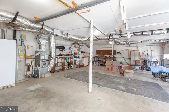 garage with water heater and a workshop area