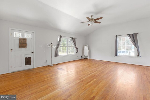 unfurnished living room with light wood finished floors, vaulted ceiling, and a ceiling fan