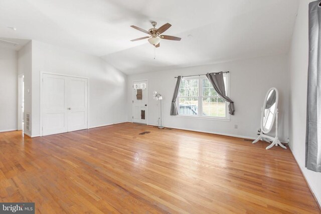 unfurnished living room featuring lofted ceiling, light wood finished floors, and ceiling fan