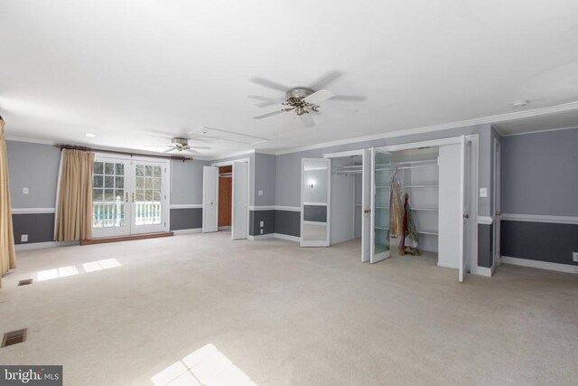unfurnished living room with a ceiling fan, carpet floors, and ornamental molding