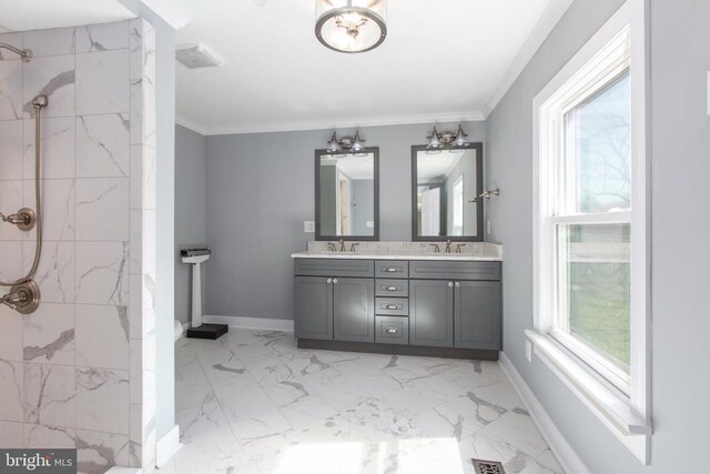 bathroom featuring ornamental molding, marble finish floor, a sink, double vanity, and tiled shower