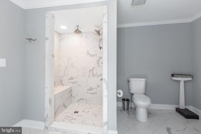 bathroom featuring crown molding, a shower stall, baseboards, marble finish floor, and toilet