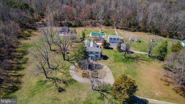 birds eye view of property featuring a view of trees