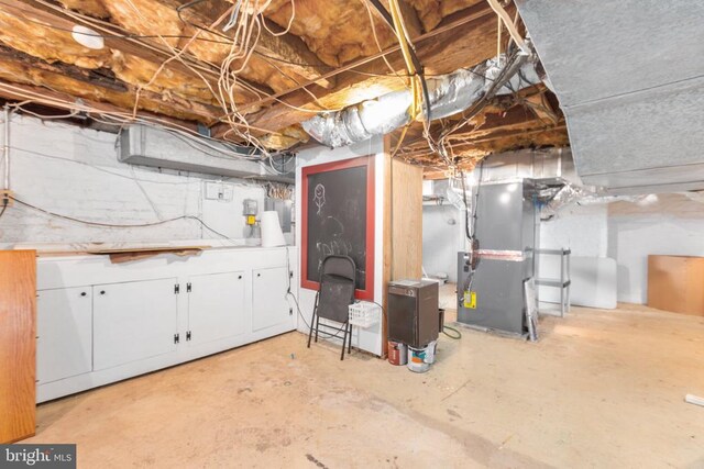 unfinished below grade area featuring heating unit