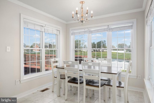 dining space featuring a chandelier, crown molding, and baseboards