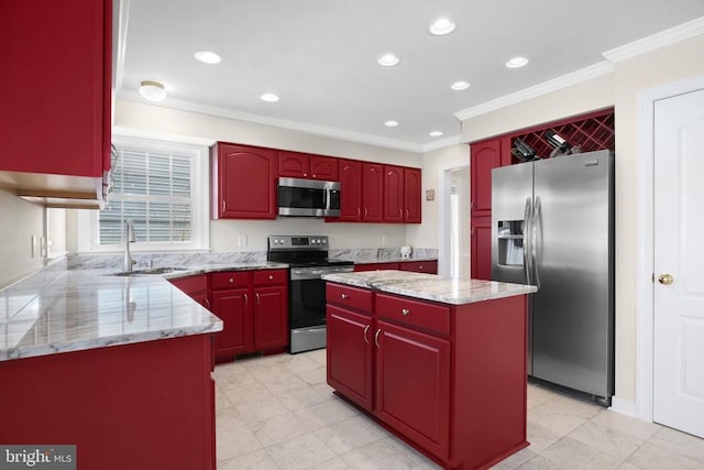 kitchen featuring light stone countertops, a sink, a kitchen island, ornamental molding, and appliances with stainless steel finishes