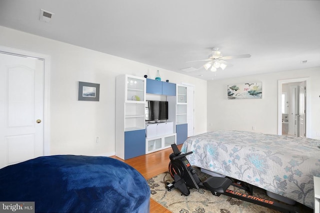 bedroom with wood finished floors, ceiling fan, and visible vents