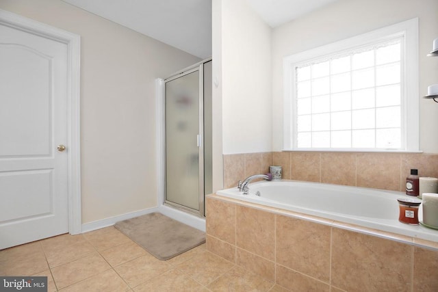 bathroom featuring a shower stall, tile patterned flooring, and a bath