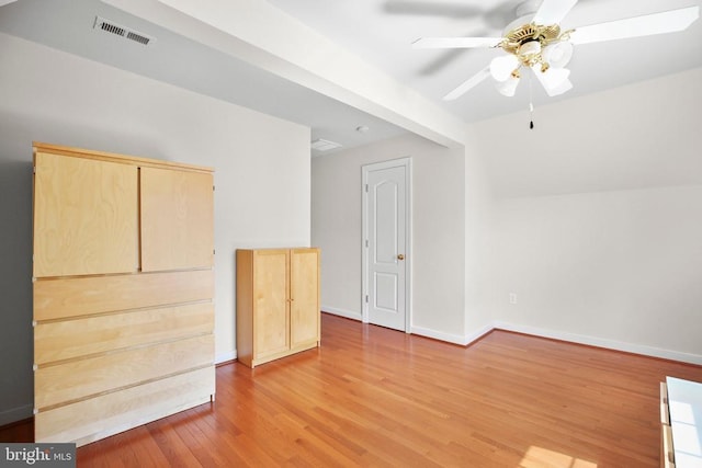 unfurnished room featuring light wood finished floors, visible vents, ceiling fan, and baseboards