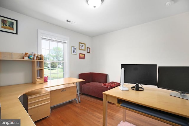 home office featuring wood finished floors and visible vents