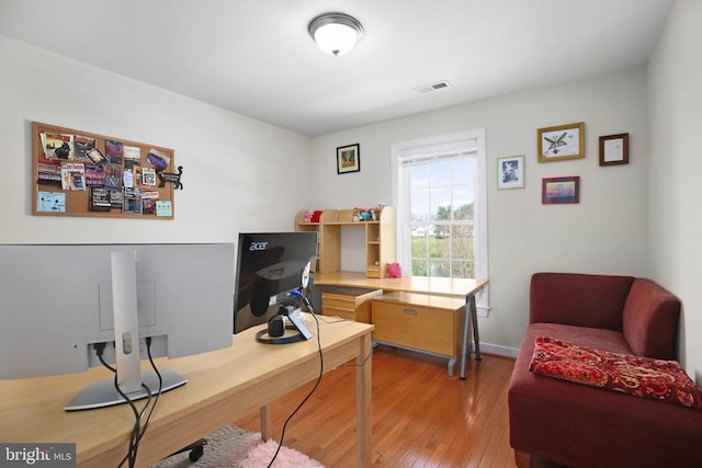 office with visible vents, baseboards, and light wood-style floors