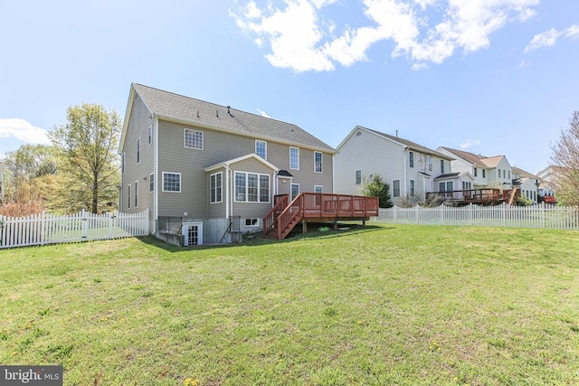 back of house featuring a deck, a fenced backyard, a yard, stairway, and a residential view