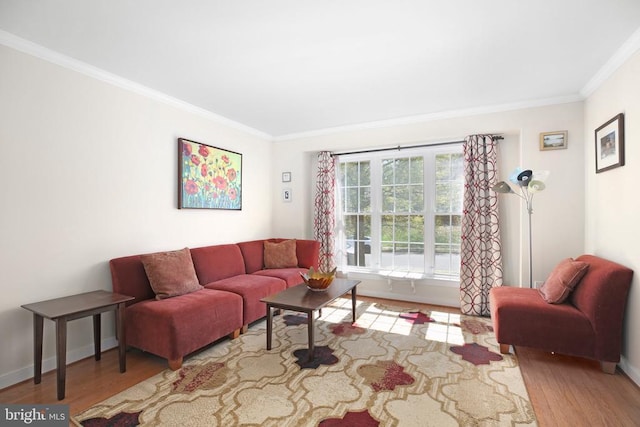 living area with baseboards, wood finished floors, and crown molding