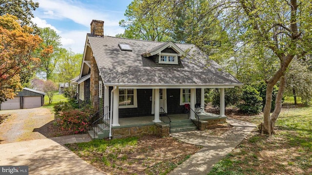535 Winchester St, Warrenton, VA 20186 - bungalow-style house featuring an outbuilding, a detached garage, a porch, a chimney, and a shingled roof