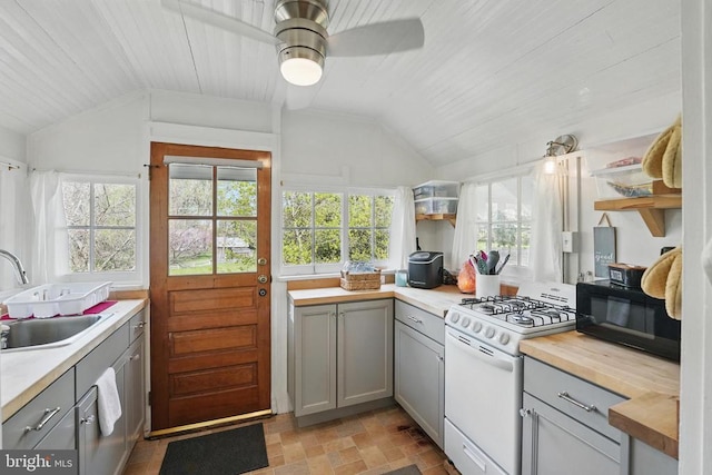 535 Winchester St, Warrenton, VA 20186 - kitchen with black microwave, white gas range, and gray cabinets