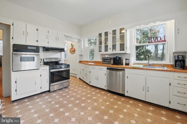 535 Winchester St, Warrenton, VA 20186 - kitchen with white cabinets, stainless steel appliances, a sink, and butcher block counters