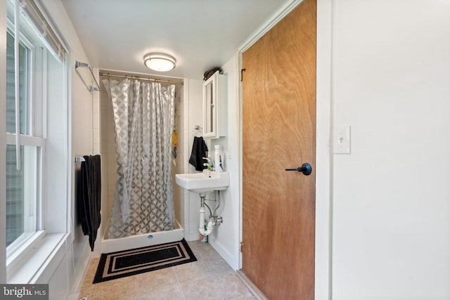 bathroom featuring tile patterned flooring and a stall shower