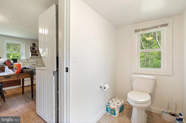bathroom featuring baseboards, toilet, and wood finished floors