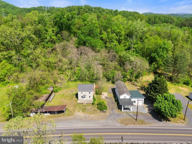 birds eye view of property with a wooded view