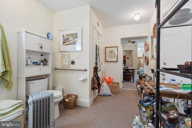 bathroom featuring radiator, baseboards, a ceiling fan, and toilet