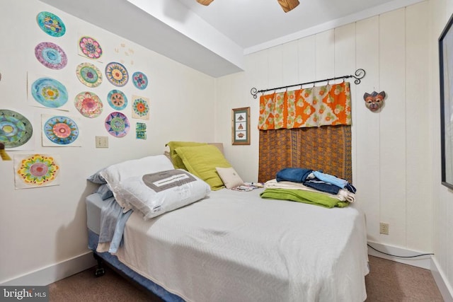 carpeted bedroom featuring baseboards and a ceiling fan