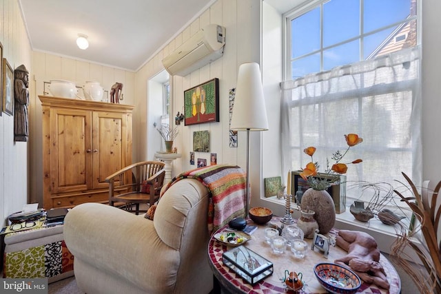 sitting room with crown molding and an AC wall unit
