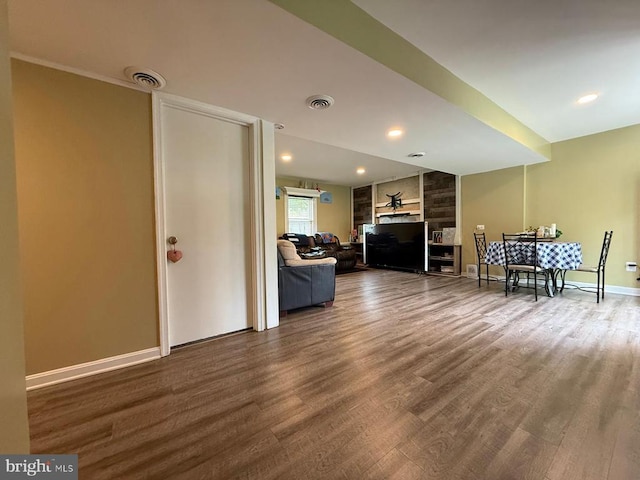  - living room featuring wood finished floors, baseboards, a fireplace, and recessed lighting