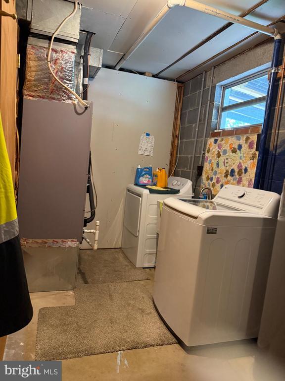  - laundry area with washer and clothes dryer and heating unit