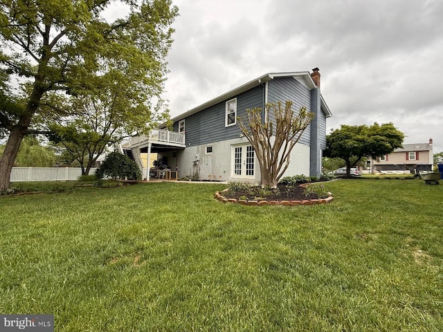 - back of property with french doors, a chimney, and a deck