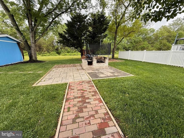  - view of yard with a trampoline and a patio