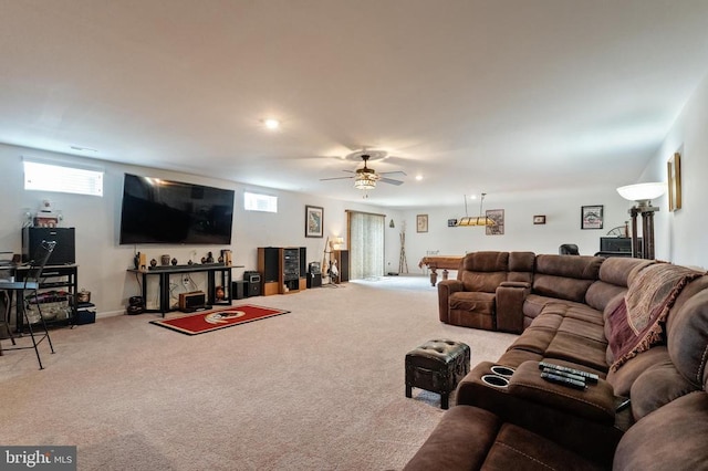 living area with carpet flooring, healthy amount of natural light, and a ceiling fan