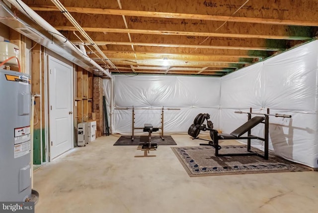 unfinished basement featuring electric water heater